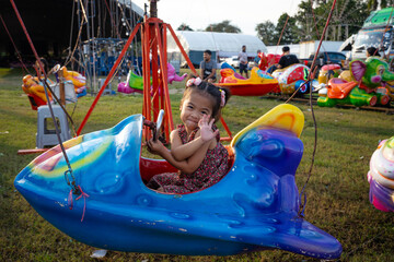 Little girl enjoy outdoor amusement city park festival