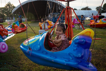 Little girl enjoy outdoor amusement city park festival