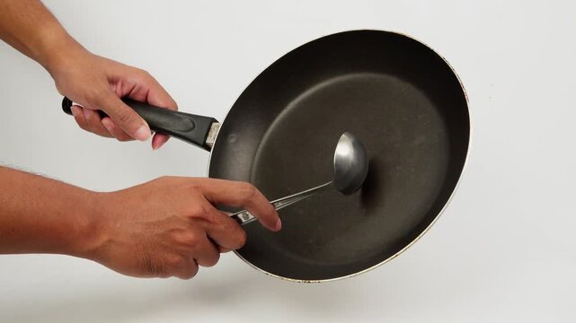 Hitting a Frying Pan with a Large Spoon