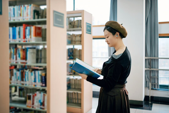 Woman Reading Book in Library with Vintage Attire