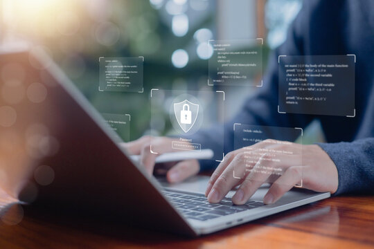 Secure login concept with person typing on laptop and digital shield lock interface, representing password protection, data encryption, cyber security, secure access, software protection technology.