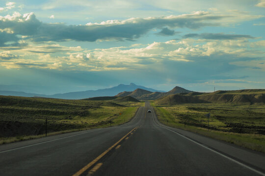 long open road in the wyoming mountains