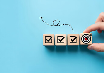 Fototapeta premium Achieving goals hand placing final block with target on wooden cubes