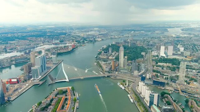 Rotterdam, Netherlands. Erasmus Bridge. Noordereiland Island. View of the city center. River Nieuwe Maas. Summer day, Rainy clouds. Drone footage