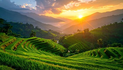 Breathtaking rice terraces glisten under a warm sunset with mountains fading into the distance and stunning cloudscapes