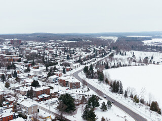 Obraz premium Aerial winter view of Granby city with snowy streets, church buildings and urban landscape, Quebec, Canada. g