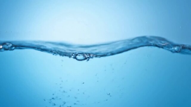 Close-up view of rippling water surface with bubbles, showcasing liquid movement and texture in a serene environment