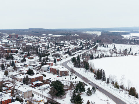 Aerial winter view of Granby city with snowy streets, church buildings and urban landscape, Quebec, Canada. g