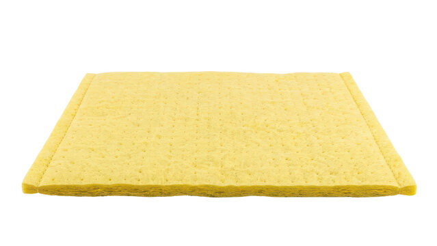 Yellow rectangular cellulose sponge cloth, absorbent cleaning pad for kitchen and household chores, isolated on white
