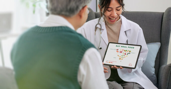 Doctor advice on dieting health food nutrition pyramid to explain balanced eating and healthy living lifestyle during a consultation