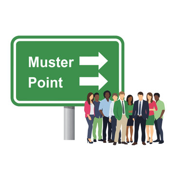 Diverse group of professionals stands before a large green directional highway sign indicating a clear muster point for organized assembly and guidance.