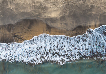 Aerial Top Down View of Hac Sa Black Sand Beach Coastline with Foaming Ocean Waves in Coloane Macau