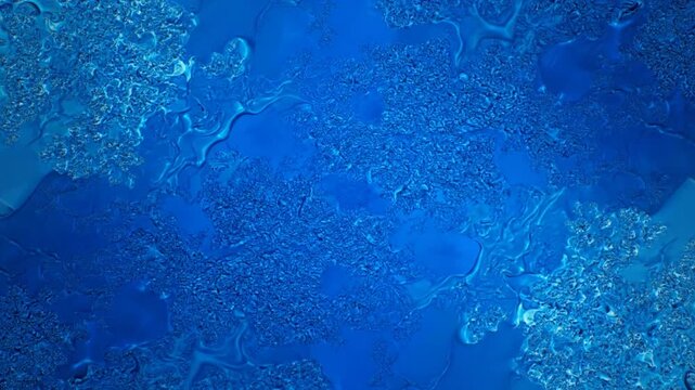 Abstract texture of frozen water droplets on a deep blue surface with intricate patterns