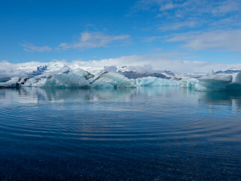 Icebergs floating in pristine blue waters of Iceland's Jokulsarlon Glacier Lagoon