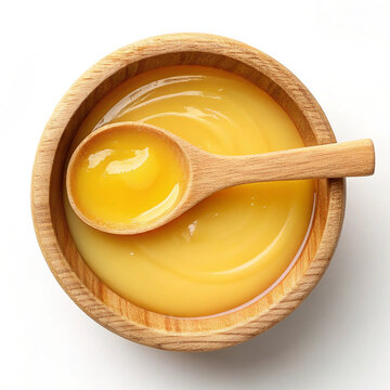 Orgenic Fresh desi ghee in wooden Bowl with wooden spoon isolated on white background.