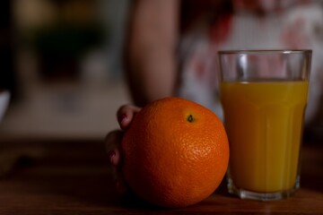 Juice and citrus scene, Bright citrus with warm tones, Vivid citrus display with cozy wooden surface, Aesthetic presentation of citrus fruits and juice on warm wooden table
