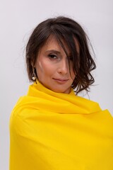 Relaxed female model with soft expression and warm styling, Charming female model showcasing seasonal clothing with gentle smile and delicate accessories in studio setting