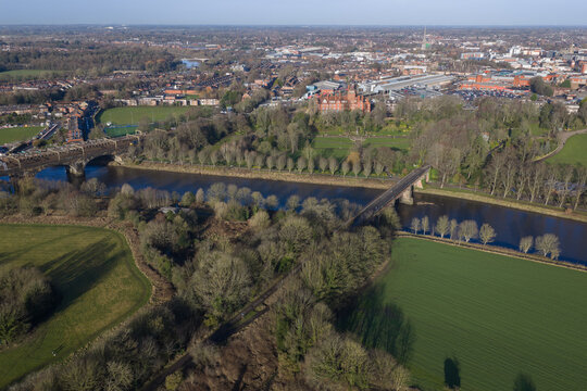 A  morning aerial image of the River Ribble in Preston, showing the North Union Railway viaduct and the green landscape of the city parks.