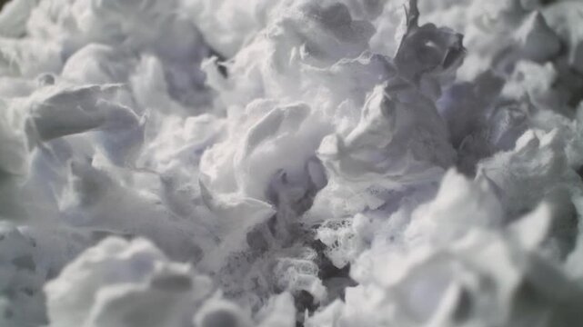 A close-up view of a fluffy white substance with a bumpy texture