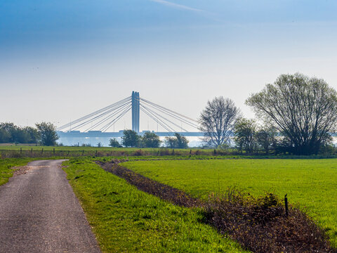 Country road leading towards Tacitus Bridge in Netherlands