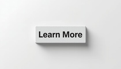 Fototapeta premium A white rectangular button with the words Learn More on a plain background