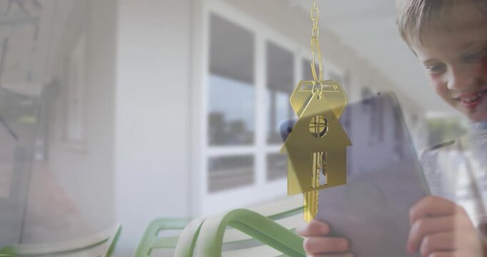 Animation of key with house keychain over caucasian boy using tablet