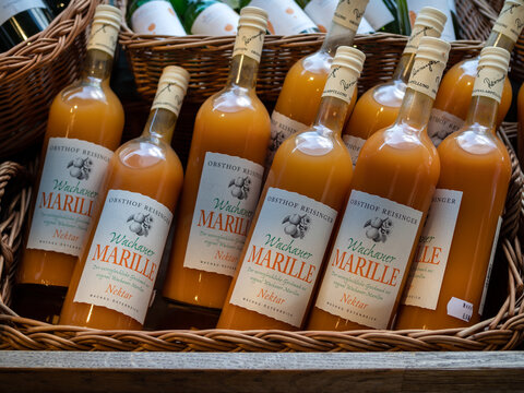 VIENNA, AUSTRIA - JULY 15, 2019:  Bottles of The Wachau Apricot (Wachauer Marille) juice in a basket at  Naschmarkt Market