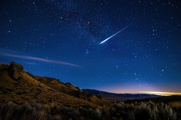 Obraz premium Bright meteor flying over a desert landscape at night with starry sky and milky way galaxy