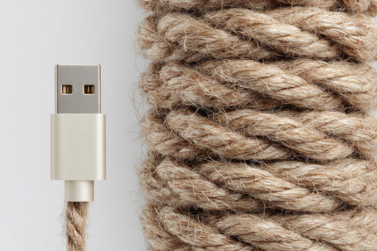 Jute rope texture and modern charging cable. Space for text.