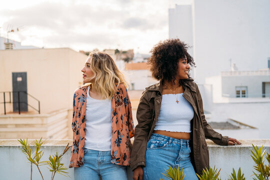 Diverse young women enjoying urban rooftop leisure time