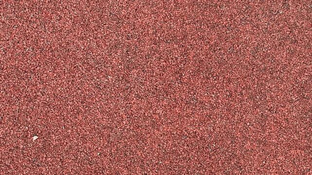 Red Gravel Surface, Compact Stones Create Sturdy Foundation, Earthy Tones With Fine Granules Ensure Durability, Slip resistant Gravel Provides Reliable Footing For Sports Facilities.