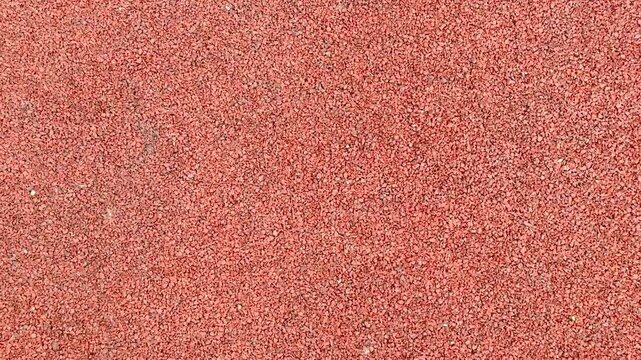 Fine Red Gravel Sports Surface Texture, Close Up View Of Compacted Small Stones Forming Uniform Matte Base For Playground And Athletic Track Earthy Tones And Fine Granules Create Engineered.
