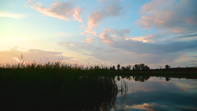 a beautiful sunset over a quiet lake in windless weather