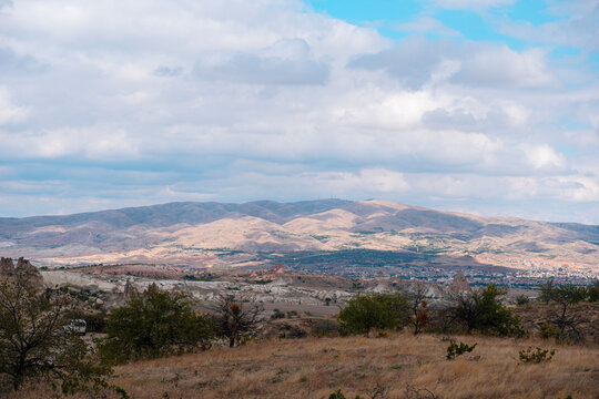 Wide landscape view of Love Valley Trail in Goreme, Cappadocia, Turkey T&uuml;rkiye, featuring distinctive fairy chimney rock formations under a clear blue