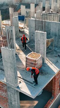 Aerial view Construction works. Builders are building another floor of a multi-story brick building.