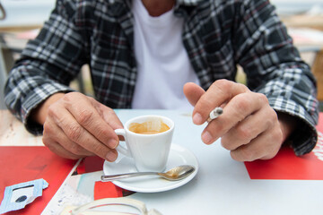 Fototapeta premium A man's hand is holding a cigarette between his two fingers