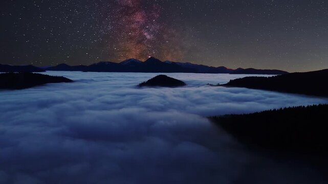 Milky Way over Clouds in Mountains Night , aerial timelapse
