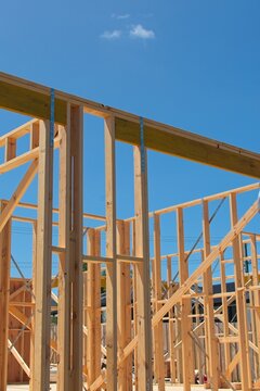 Timber house framing on an Australian house under construction.   Pine wood stud wall frames on a house under construction in Australia; a symbol of the housing property crisis.