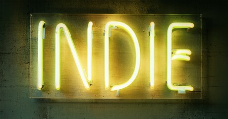 Obraz premium Bright neon sign spells INDIE against textured wall. Yellow glow dominates dark background, creating bold visual impact. Simple, modern aesthetic.