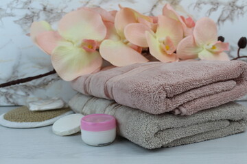 there are towels and care cream on the table