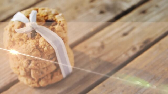 Animation of light moving over christmas cookies on wooden surface