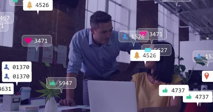 Coworkers leaning over laptop in marketing office, with floating social media notification overlays