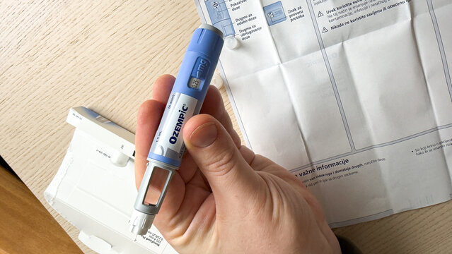 A hand holds a vibrant blue Ozempic pen, echoing modern wellness rituals amidst World Health Day reflections, Ozempic, GLP 1, Semaglutide, January 5 2026, Subotica, Serbia