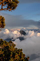 Fototapeta premium Hikers rewarded with a spectacular sunset from Acatenango volcano as golden light washes over the rugged peaks of Central America