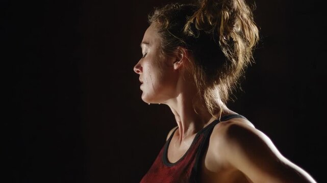 Medium shot capturing raw emotion and unfiltered expression as dancers explore intense primal movements in a dimly lit rehearsal room