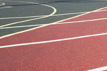 Fototapeta premium Sport floor. Interior of empty modern indoor sport court, coating Crumb rubber flooring, artificial. Sports surface with different marking lines. Recycled rubber Athletic field. Run track markup. 4K