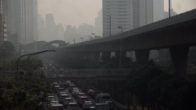 Cityscape of Bangkok covered by mixture of dust in air pollution. Heavy air pollution of fine particulate matter (PM2.5) in morning.