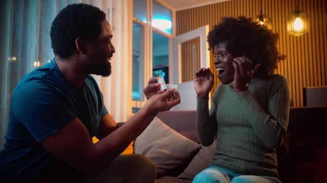 happy couple marriage proposal young man in love proposing to girlfriend enjoying romantic surprise engagement ring hugging boyfriend smiling excited 4k