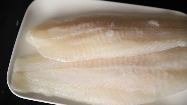 Frozen fish fillet white fish pangasius seafood tasty snack fresh gourme pescetarian diet food background on the table rustic food top view copy space keto and paleo diet food