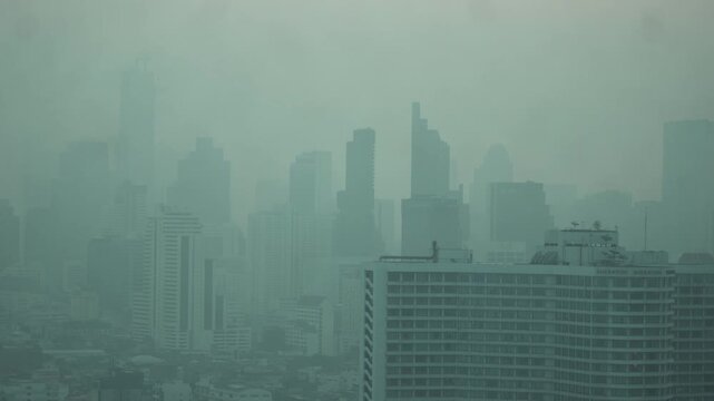Cityscape of Bangkok covered by mixture of dust in air pollution. Heavy air pollution of fine particulate matter (PM2.5) in morning.